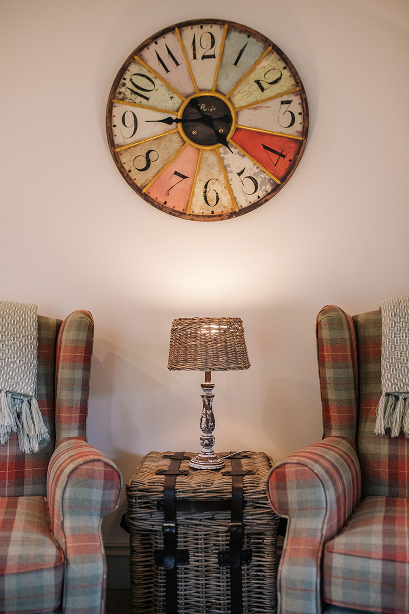 Clock and armchairs in The Nook living room